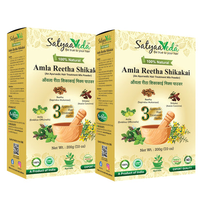 Two boxes of SatyaaVeda Amla Reetha Shikakai hair treatment mix powder on a white background.